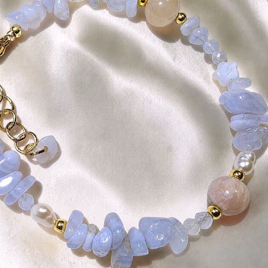 Close up detail of natural chalcedony flower agate patterns and soft blue lace agate gemstone beads on an elastic handmade bracelet.