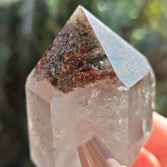 Garden quartz crystal tower with chlorite inclusions forming landscape patterns and clear quartz base