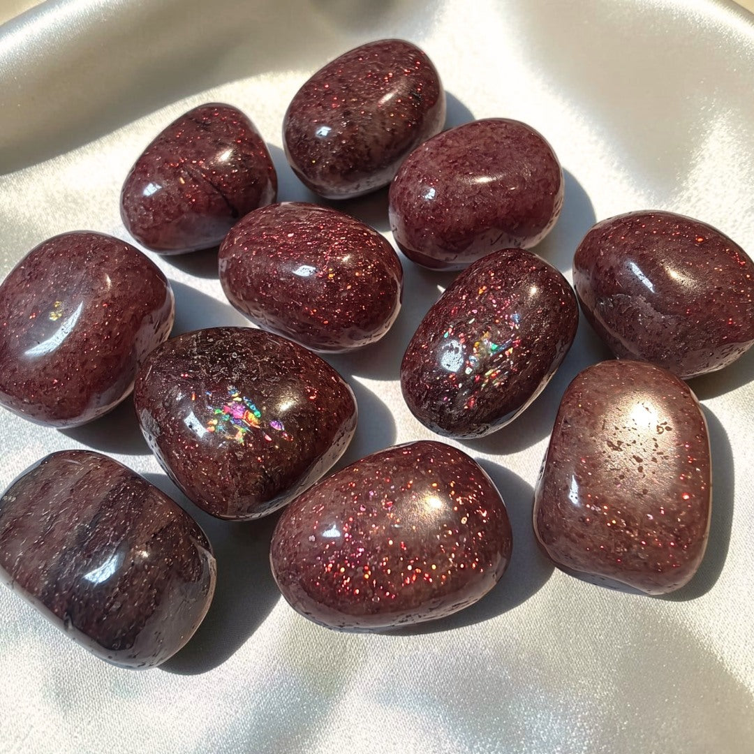Natural Strawberry Quartz tumbled stone with soft pink tones and red mineral inclusions