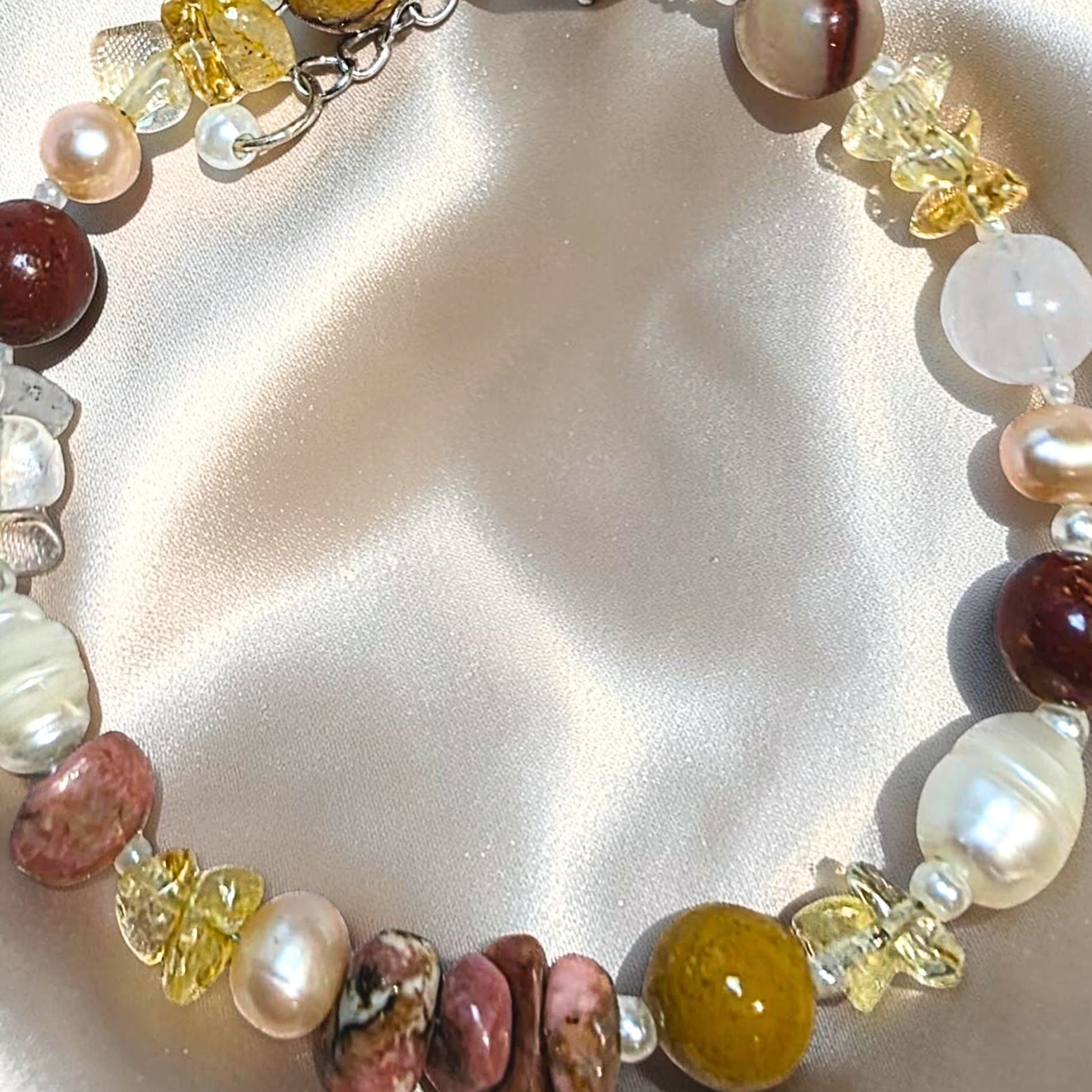 Detail shot of genuine Freshwater Pearls, pink Rhodonite chips, and Citrine chips