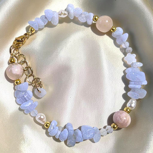 Handcrafted Bluebell Reverie bracelet featuring pastel blue banded lace agate beads, flower agate, and white freshwater pearls.