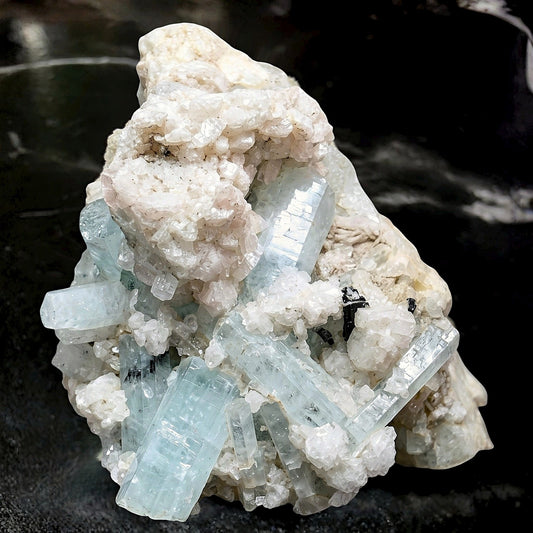 92g Aquamarine and black schorl tourmaline cluster from Pakistan on a neutral background.